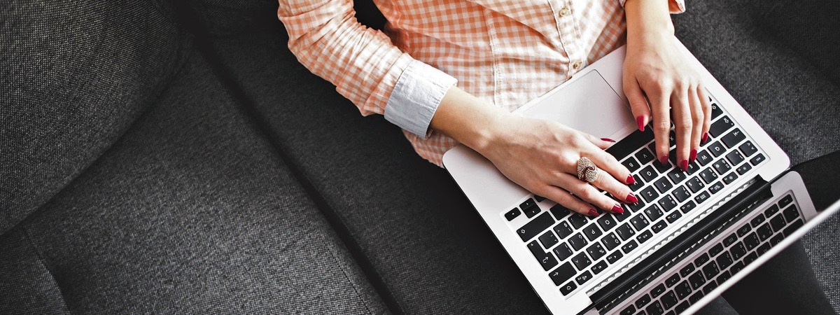 Woman writing review on laptop